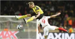  ??  ?? MONACO: Dortmund’s defender Matthias Ginter (L) and Monaco’s Colombian forward Radamel Falcao go for the ball during the UEFA Champions League 2nd leg quarterfin­al football match AS Monaco v BVB Borussia Dortmund yesterday at the Louis II stadium in...