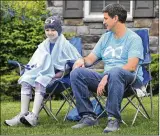  ?? MARSHALL GORBY
/ STAFF ?? Emma
Palmer, 11, sits with father, Andy Palmer, outside their Lebanon home Thursday waiting for a parade of family and friends to drive by.