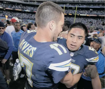  ?? Donald Miralle/AFP/ Getty Images ?? San Diego Chargers’ Philip Rivers and Manti Te’o celebrate after a 27-24 overtime win against the Kansas City Chiefs Sunday in San Diego.