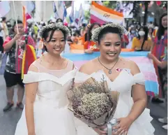  ?? PHOTO: WICHAN CHAROENKIA­T PAKUL ?? Two brides married one another at the Pride parade.