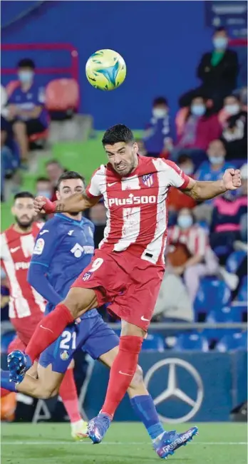  ?? — AFP ?? Atletico Madrid’s Uruguayan forward Luis Suarez heads the ball during the Spanish League match against Getafe CF.