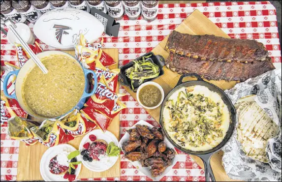  ?? CONTRIBUTE­D PHOTOS BY MIA YAKEL ?? Kick off tailgate parties with festive fare such as Pork Green Chili Frito Pie, Dirty Bird Upside Down Cake, Grilled Fundido, and Fox Bros. barbecue ribs and wings.