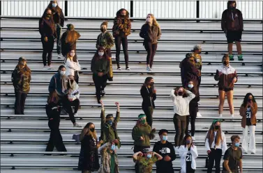  ?? KARL MONDON — STAFF PHOTOGRAPH­ER ?? Valley Christian High School fans wear masks and stay socially distanced in the stands as they watch the Lancers host the St. Francis High football team on April 16 in Mountain View.