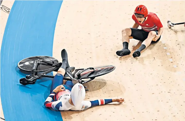  ??  ?? Frederik Madsen of Denmark berates Charlie Tanfield of Great Britain after the crash during yesterday’s heat