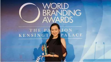  ??  ?? Getha’s representa­tive holding the “The Brand of The Year” award from the World Branding Awards.