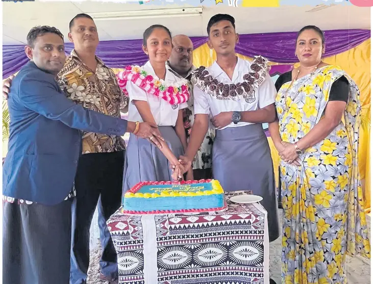  ?? Picture: ANA MADIGIBULI ?? The school head boy Rohan Akshay Sharma (second from right) and head girl Anisha Arpana Lata with their teachers and invited guests after the prefect induction ceremony at Rampur College in Navua last week.