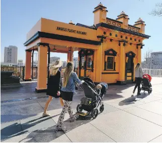  ?? RICHARD VOGEL/THE ASSOCIATED PRESS FILES ?? Visitors walk past Angels Flight Railway in Los Angeles, which was one of many recognizab­le destinatio­ns in the city to be featured in La La Land.