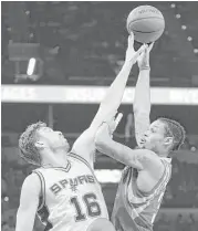  ?? Darren Abate / Associated Press ?? Rockets guard K.J. McDaniels, right, tries to go up and over Spurs center Pau Gasol.