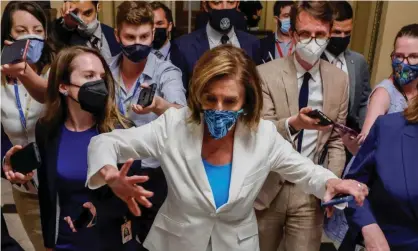  ??  ?? The House speaker, Nancy Pelosi, is trailed by reporters as she departs a meeting with fellow House Democrats about Joe Biden’s sweeping plan to expand spending on social programs, at the US Capitol on Monday. Photograph: Jonathan Ernst/Reuters