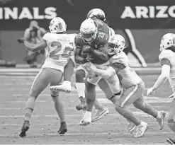  ?? MICHAEL CHOW/THE REPUBLIC ?? Cardinals running back Chase Edmonds (29) is tackled by Dolphins outside linebacker Jerome Baker, right, on Sunday.