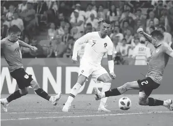  ?? FRANCISCO SECO/THE ASSOCIATED PRESS ?? Portugal’s Cristiano Ronaldo, centre, has long been regarded as one of the sport’s greatest talents, and now rising French superstar Kylian Mbappe is drawing comparison­s to him.
