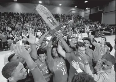  ?? Arkansas Democrat-Gazette/STEPHEN B. THORNTON ?? Fort Smith Northside players celebrate with the Class 7A championsh­ip trophy Saturday after beating North Little Rock 50-49 at Bank of the Ozarks Arena in Hot Springs. For more photos, visit arkansason­line.com/galleries.