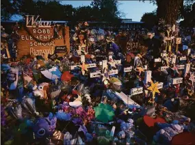  ?? Katherine Frey / The Washington Post ?? A massive memorial to the 19 students and two teachers killed May 24 at Robb Elementary is bathed in streetligh­ts in Uvalde, Texas. Survivors of the Robb Elementary School shooting are suing law enforcemen­t officers and the city of Uvalde, Texas, for $27 billion over their response to the May shooting, claiming they failed to stop the gunman from killing 19 children and two teachers.