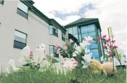  ?? GRAHAM HUGHES THE CANADIAN PRESS FILE PHOTO ?? Plush toys and flowers are seen in May outside Résidence Herron, a long-term-care home in Dorval, Que., where 31 residents died in less than a month in April after contractin­g COVID-19.