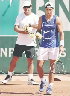  ??  ?? Nadal (right) and his coach Toni attend a training session. — Reuters photo