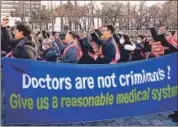  ?? AP ?? Doctors stage a rally against the government’s medical policy near the presidenti­al office in Seoul, South Korea, on Sunday.