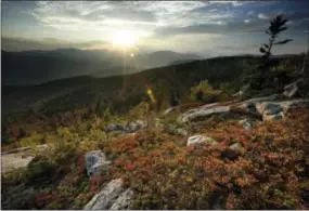  ?? THE ASSOCIATED PRESS ?? The sun begins to set Sept. 27 in this view from South Moat Mountain in Albany, N.H.