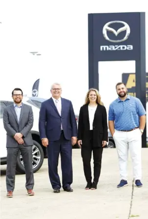  ?? STAFF PHOTO BY C.B. SCHMELTER ?? From left: Jesse Morgan, Brent Morgan, Abigail Lockhart and Bailey Morgan stand in front of Integrity Mazda on Friday. Jesse, Abigail and Bailey are vice presidents and Brent is the president of Integrity Automotive Group.