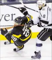  ?? Steven Senne Associated Press ?? BOSTON center Dominic Moore and Kings defenseman Drew Doughty grapple during the first period.