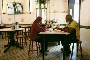  ??  ?? Just them: Abdul Rani Jaafar and his wife Saadah Sohor having a meal at the otherwise empty Ah Hock Kopitiam in Kuala Lumpur. — AZMAN GHANI/ The Star