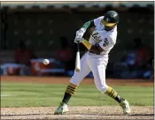  ?? JOHN HEFTI — THE ASSOCIATED PRESS ?? The Oakland Athletics’ Tony Kemp hits a single against the Houston Astros in the seventh inning Sunday in Oakland.