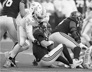  ?? JOHN MCCALL PHOTOS/SUN SENTINEL ?? Dolphins defensive lineman Adam Butler sacks Giants quarterbac­k Mike Glennon during the second half Sunday at Hard Rock Stadium in Miami Gardens.