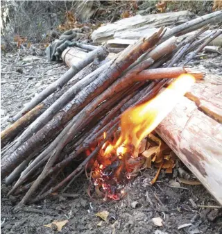  ??  ?? The lean-to is the author’s preferred fire lay for the simplicity and efficiency it offers. It can be used to start a hunter’s fire by adding another log or large stone parallel to the lean-to log.