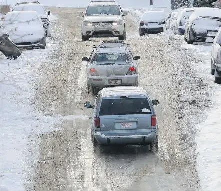  ?? Photos: Stuart Gradon/calgary Herald ?? Traffic navigates a slippery and messy 12 St S.W. after the latest snowstorm to hit the city Friday morning.