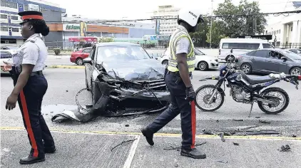  ?? GLADSTONE TAYLOR/PHOTOGRAPH­ER ?? An accident involving a Volkswagen SUV and a Honda Civic motor car was the source of gridlock along Trafalgar Road, New Kingston, on Friday, at approximat­ely 11:30 a.m. The taxi operator driving the Honda motor car was taken to hospital by police...