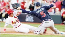  ??  ?? St. Louis Cardinals’ Tommy Edman (19) slides back into first as Atlanta Braves first baseman Freddie Freeman (5) waits for the throw from Nick Markakis during the ninth inning in Game 4 of a baseball National League
Division Series, on Oct 7 in St Louis. (AP)
