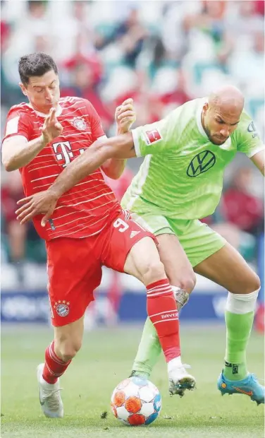  ?? Agence France-presse ?? Bayern Munich’s Robert Lewandowsk­i (left) vies for the ball with Wolfsburg’s John Anthony Brooks during their German League match on Saturday.