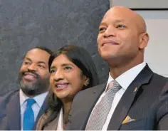  ?? AMY DAVIS/BALTIMORE SUN ?? Baltimore City Council President Nick Mosby, from left, Lt. Gov. Aruna Miller and Gov. Wes Moore listen to speakers at the grand opening ceremony for the new Lexington Market last month. In recent weeks, Moore and Mosby have followed different paths on ethics rules.