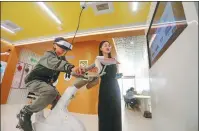  ?? PROVIDED TO CHINA DAILY ?? Left: A student tries a virtual reality spinning session that helps relieve users of negative emotions at a mental health center in Jiaxing, Zhejiang, in May.