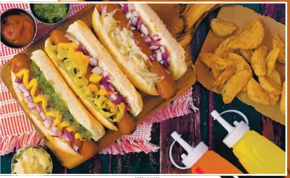  ?? GETTY IMAGES ?? Think beyond the ballpark mustard when dressing your hot dogs, and go creative with the toppings and sauces.