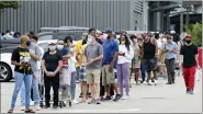  ?? GERALD HERBERT — THE ASSOCIATED PRESS ?? People line up to enter retail chain Costco to buy provisions in New Orleans on Sunday in advance of Hurricane Marco, expected to make landfall on the southern Louisiana coast.