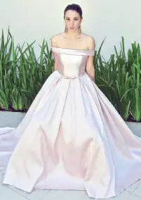  ??  ?? Susie Bonaobra’s off-shoulder corseted top with ball gown skirt in pink whisper Mikado silk.