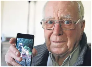  ??  ?? Leonard Ormond with a photograph of his dog Rosco, who was stolen from his garden, and, above, the pair after being reunited.