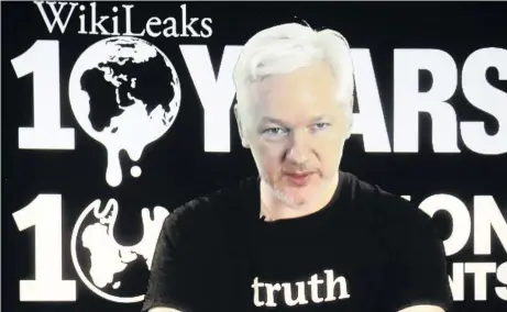  ??  ?? > WikiLeaks founder Julian Assange participat­es via video-link at a news conference in Berlin