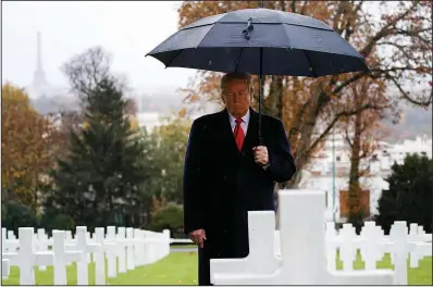  ?? AP/JACQUELYN MARTIN ?? President Donald Trump stands among headstones at the Suresnes American Cemetery near Paris on Sunday during an American Commemorat­ion Ceremony. Trump attended events in Paris marking the centennial of the end of World War I.