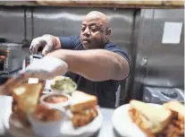  ?? ?? Eric Vernon, third-generation owner of The BAR-B-Q Shop, boasts its sandwich as the most consistent in Memphis.