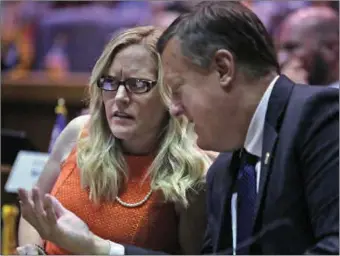  ?? ?? Indiana state Senator Erin Houchin, R-Salem, left, speaks with Sen. Eric Koch, R-Bedford during a legislativ­e hearing at the Indiana Statehouse in Indianapol­is on Aug. 21, 2021. American Dream Federal Action, a super PAC financed by a cryptocurr­ency CEO, saturated the district with ads promoting Houchin as a “Trump Tough” conservati­ve who would “stop the socialists in Washington.” That push helped secure her win last week in a Republican primary.