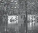  ?? ALICIA DEVINE/TALLAHASSE­E DEMOCRAT ?? Residents in mobile homes had to be rescued by the Leon County (Fla.) Sheriff’s Office with a boat after heavy rains flooded the neighborho­od Thursday.