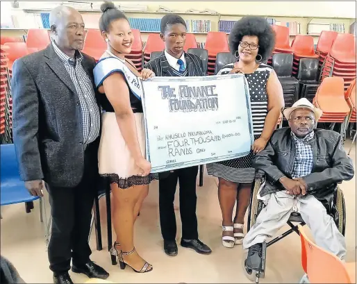  ?? Picture: SUPPLIED ?? FINANCIAL LIFT: Pupil Khuselo Nkunkuma, centre, receives R4 000 from Zokhanye Funani, second from the left, and Zothando Funani, second from the right. Left is the principal of Thomas Ntaba secondary school, Themba Funani, and right is Lucas Boy Ngcwangu