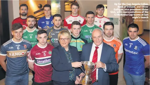  ?? PETER MORRISON ?? Up for the Cup: Angela Callan,Bank of Ireland, and Oliver Galligan, vice president Ulster GAA, with representa­tives of the 12 McKenna Cup teams at lastnight’s launch