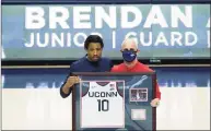  ?? David Butler II / Associated Press ?? UConn guard Brendan Adams (10), left, with head coach Dan Hurley, is recognized during senior day on March 6.