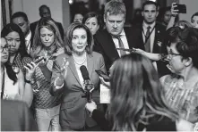  ?? Erin Schaff / New York Timies ?? Reporters follow House Speaker Nancy Pelosi on Tuesday in Washington. The House passed a measure to condemn President Donald Trump over his tweets by a vote of 240-187.