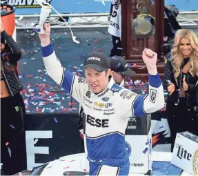  ?? JARED C. TILTON/GETTY IMAGES ?? Brad Keselowski celebrates in victory lane Sunday in Martinsvil­le, Virginia.