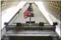  ?? RICHARD DREW — THE ASSOCIATED PRESS FILE ?? The American flag flies above the Wall Street entrance to the New York Stock Exchange. Stock markets around the world edged lower Thursday as investors digested an upbeat Fed assessment of the U.S. economy that raised the prospect of further rate...