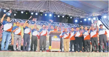  ??  ?? Dr Rundi (sixth left) with Harden (fifth left), Len (seventh left), Sikie (eighth left) and others wave the national flags as they sing the national anthem.