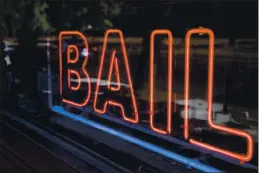  ?? DAI SUGANO — BAY AREA NEUS GROUP ?? A neon sign is seen in the window of Bad Boys Bail Bonds on in San Jose.